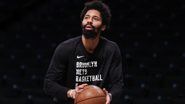 Nets point guard shoots a ball during warmups before a game.
